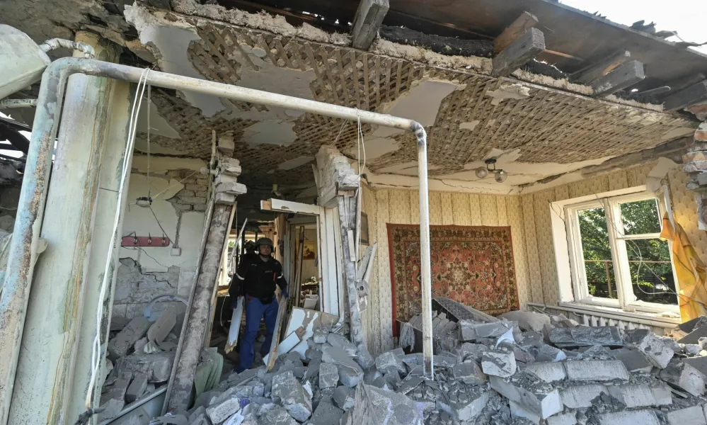 Rescuers inspect a house heavily damaged by a Russian air strike, amid Russia's attack on Ukraine, in Zaporizhzhia, Ukraine October 10, 2024. REUTERS/Stringer