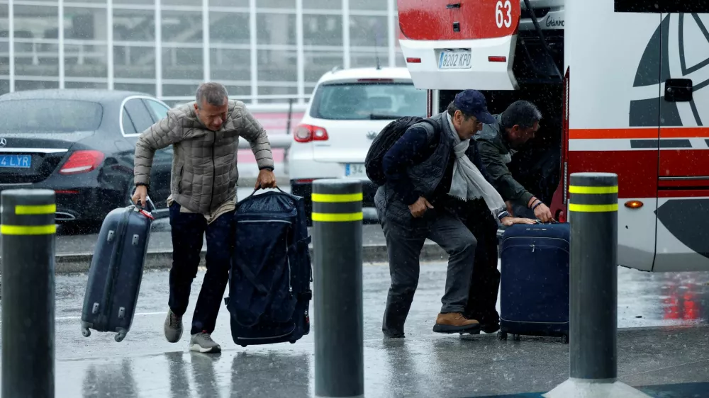 Passengers arrive at the airport as flights are delayed because of high winds from Storm Kirk, at Bilbao Airport in Loiu, Spain, October 9, 2024. REUTERS/Vincent West