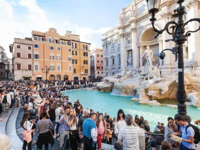 Rome, Italy - November 1, 2016: crowd of tourists and Trevi Fountain in Rome city. It is it is the largest Baroque fountain in the Rome and one of the most famous fountains in the world.