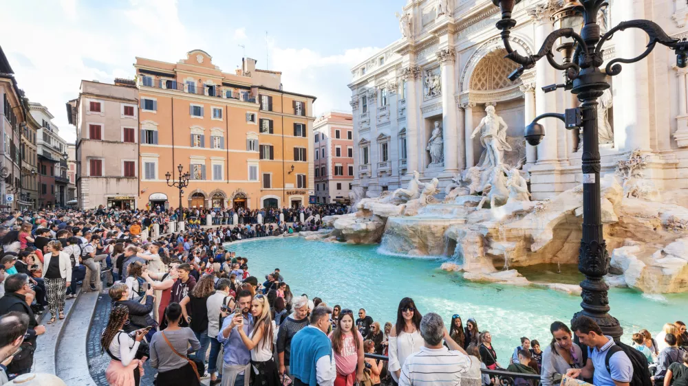 Rome, Italy - November 1, 2016: crowd of tourists and Trevi Fountain in Rome city. It is it is the largest Baroque fountain in the Rome and one of the most famous fountains in the world.