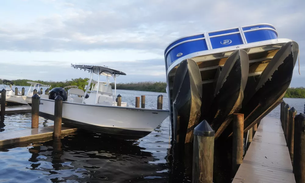 Small boats rests on a pier after they were unmoored during Hurricane Milton, Thursday, Oct. 10, 2024, in Fort Myers, Fla. (AP Photo/Marta Lavandier)