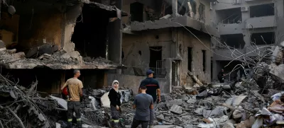 People inspect the site of an Israeli air strike, amid ongoing hostilities between Hezbollah and Israeli forces, in Beirut, Lebanon, October 11, 2024. REUTERS/Louisa Gouliamaki