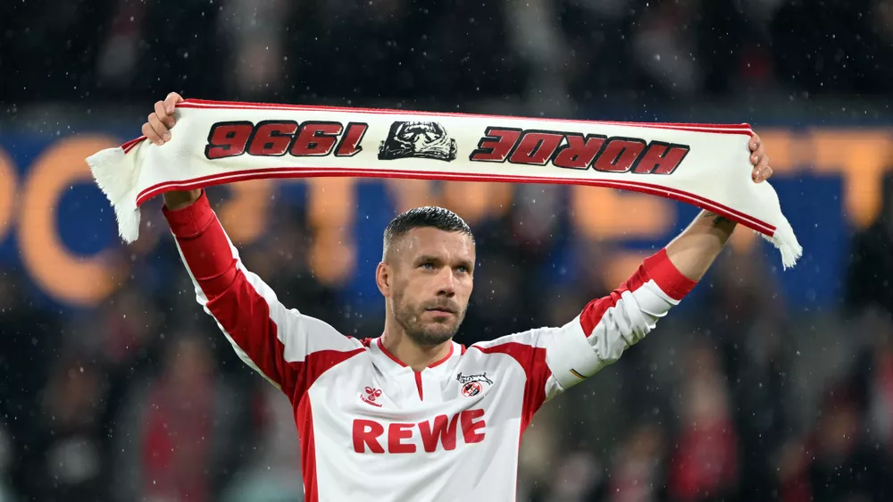 10 October 2024, North Rhine-Westphalia, Cologne: German footballer Lukas Podolski celebrates with the fans during the Lukas Podolski's farewell match. Photo: Federico Gambarini/dpa