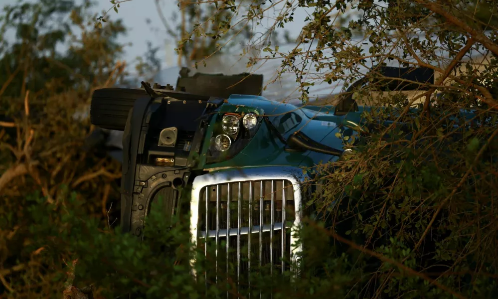 A vehicle lies on its side, after Hurricane Milton made landfall, in Lakewood Park, near Fort Pierce, in St. Lucie County, Florida, U.S., October 10, 2024. REUTERS/Jose Luis Gonzalez