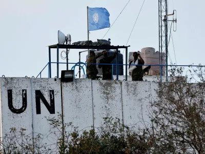 FILE PHOTO: Members of the United Nations peacekeepers (UNIFIL) look at the Lebanese-Israeli border, as they stand on the roof of a watch tower ‏in the town of Marwahin, in southern Lebanon, October 12, 2023. REUTERS/Thaier Al-Sudani/File Photo