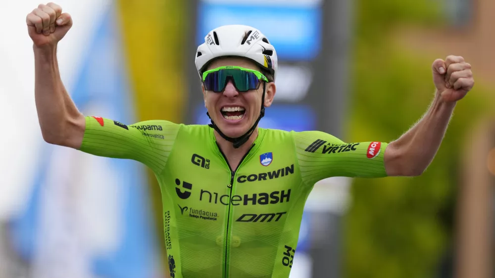 Slovenia's Tadej Pogacar crosses the finish line to win the Men Elite road race of the Cycling and Para-cycling Road World Championships in Zurich, Switzerland, Sunday, Sept. 29, 2024. (AP Photo/Peter Dejong)