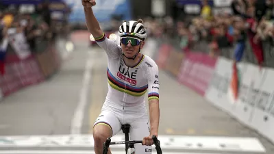 Reigning World Champion Slovenia's Tadej Pogacar celebrates winning Il Lombardia, Tour of Lombardy cycling race, in Como, Italy, Saturday, Oct. 12, 2024. (Marco Alpozzi/LaPresse via AP)