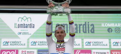 Reigning World Champion Slovenia's Tadej Pogacar celebrates on the podium after winning Il Lombardia, Tour of Lombardy cycling race, in Como, Italy, Saturday, Oct. 12, 2024. (Gian Mattia D'Alberto/LaPresse via AP)