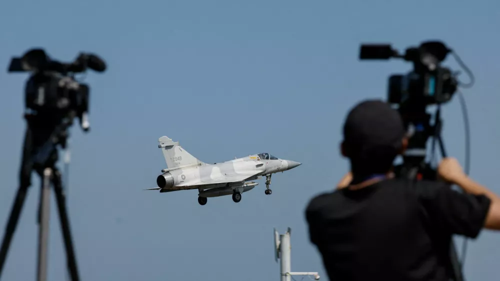 A member of the media takes a video of a Taiwan Air Force Mirage 2000 aircraft preparing to land at Hsinchu Air Base in Hsinchu, Taiwan October 14, 2024. REUTERS/Tyrone Siu