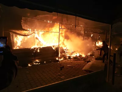 Palestinians try to extinguish fire caused by an Israeli strike that hit a tent area in the courtyard of Al Aqsa Martyrs hospital in Deir al-Balah, Gaza Strip, Monday, Oct. 14, 2024. (AP Photo/Abdel Kareem Hana)