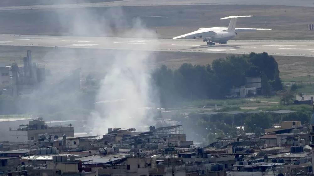 A plane take off from Rafik Hariri international airport as smoke of a past Israeli airstrike still rise from Dahiyeh, in Beirut, Lebanon, Monday, Oct. 14, 2024. (AP Photo/Hussein Malla)