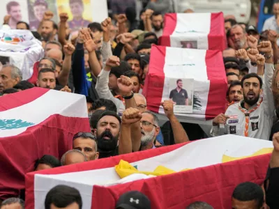 Mourners carry the coffins of their relatives, killed on Saturday in an Israeli airstrike, during their funeral procession in Maisara near the northern coastal town of Byblos, Lebanon, Monday, Oct. 14, 2024. (AP Photo/Hassan Ammar)