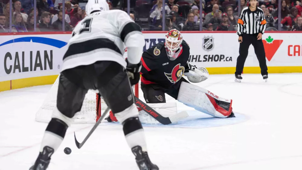 Oct 14, 2024; Ottawa, Ontario, CAN; Ottawa Senators goalie Mads Sogaard (40) follows Los Angeles Kings center Anze Kopitar (11) who controls the puck in the second period at the Canadian Tire Centre. Mandatory Credit: Marc DesRosiers-Imagn Images