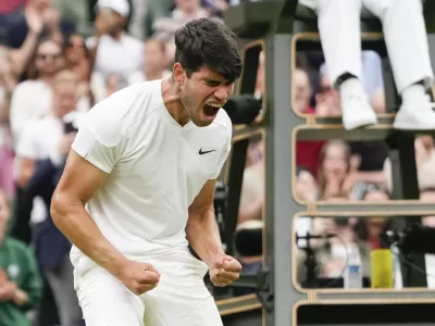 Carlos Alcaraz of Spain reacts after defeating Ugo Humbert of France in their fourth round match at the Wimbledon tennis championships in London, Sunday, July 7, 2024. (AP Photo/Alberto Pezzali)