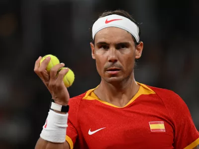 27 July 2024, France, Paris: Spanish tennis player Rafael Nadal holds tennis balls in his hand during his men's doubles 1st round tennis match with Spain's Carlos Alcaraz against Argentina's Maximo Gonzalez and Andres Molteni at Roland-Garros on the first day of the 2024 Paris Olympic Games in France. Photo: Marijan Murat/dpa