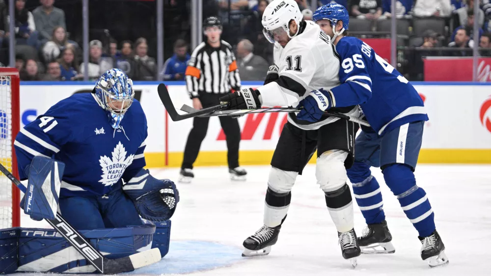 Oct 16, 2024; Toronto, Ontario, CAN; Toronto Maple Leafs goalie Anthony Stolarz (41) makes a save as defenseman Oliver Ekman-Larsson (95) covers Los Angeles Kings forward Anze Kopitar (11) in the second period at Scotiabank Arena. Mandatory Credit: Dan Hamilton-Imagn Images