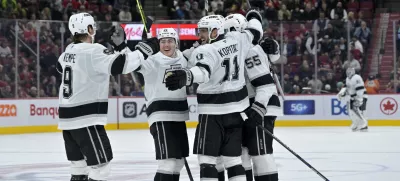 Oct 17, 2024; Montreal, Quebec, CAN; Los Angeles Kings defenseman Andreas Englund (5) celebrates with teammates including forward Anze Kopitar (11) and forward Adrian Kempe (9) after scoring a goal against the Montreal Canadiens during the third period at the Bell Centre. Mandatory Credit: Eric Bolte-Imagn Images