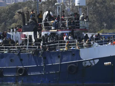 A ship carrying some 700 migrants enters the Sicilian port of Catania, Wednesday, April 12, 2023. Italy's right-wing government has declared a state of emergency to help it cope with a surge in migrants arriving on the country's southern shores. Premier Giorgia Meloni and her Cabinet on Tuesday, decided to impose the emergency status for six months. (AP Photo/Salvatore Cavalli)