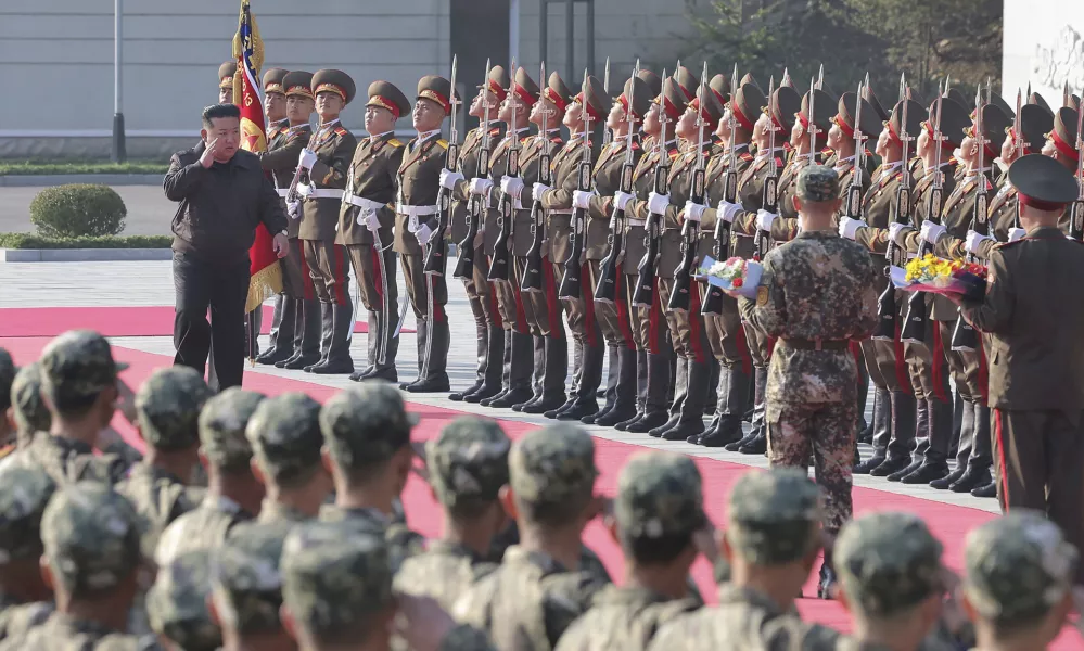 In this photo provided by the North Korean government, North Korean leader Kim Jong Un, left on red carpet, visits the headquarters of the North Korean People's Army's 2nd Corps at an undisclosed place in North Korea Thursday, Oct. 17, 2024. Independent journalists were not given access to cover the event depicted in this image distributed by the North Korean government. The content of this image is as provided and cannot be independently verified. (Korean Central News Agency/Korea News Service via AP)