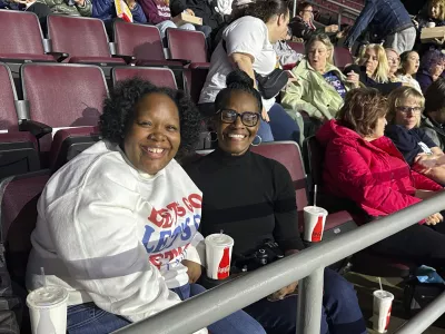  Angela Cox, center, and her adult daughter, Taylor Norton, left, await the start of a Democratic presidential candidate Vice President Kamala Harris rally at the Erie Insurance Arena in Erie, Pa., Monday, Oct. 14, 2024. (AP Photo/Carolyn Thompson)