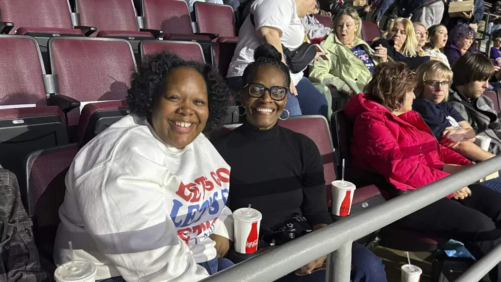  Angela Cox, center, and her adult daughter, Taylor Norton, left, await the start of a Democratic presidential candidate Vice President Kamala Harris rally at the Erie Insurance Arena in Erie, Pa., Monday, Oct. 14, 2024. (AP Photo/Carolyn Thompson)