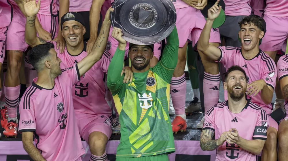 Inter Miami forward Lionel Messi, front right, celebrates with his teammates Sergio Busquets, front left, Luis Suárez, second row, left, and Drake Callender, center in green, after winning the Supporters' Shield defeating the New England Revolution at Chase Stadium in Fort Lauderdale, Fla., Saturday, Oct. 19, 2024. (David Santiago/Miami Herald via AP)