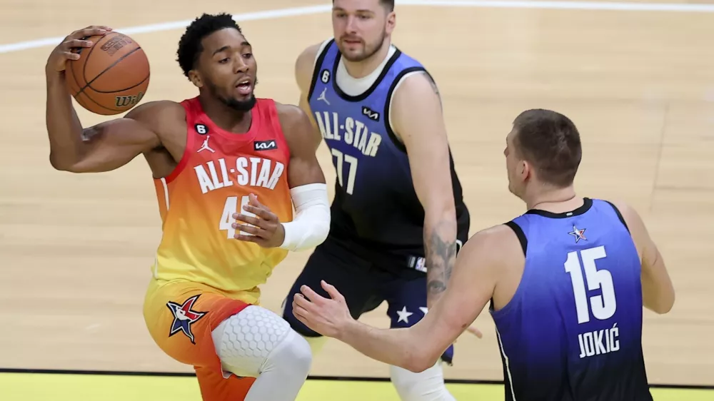 Team Giannis guard Donovan Mitchell (45) drives past Team LeBron forward Luka Doncic (77) and Team LeBron center Nikola Jokic (15) during the first half of the NBA basketball All-Star game Sunday, Feb. 19, 2023, in Salt Lake City. (AP Photo/Rob Gray)