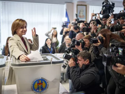 Moldova's President Maia Sandu prepares to cast her vote, in Chisinau, Moldova, Sunday, Oct. 20, 2024, during a presidential election and a referendum on whether to enshrine in the Constitution the country's path to European Union membership. (AP Photo/Vadim Ghirda)