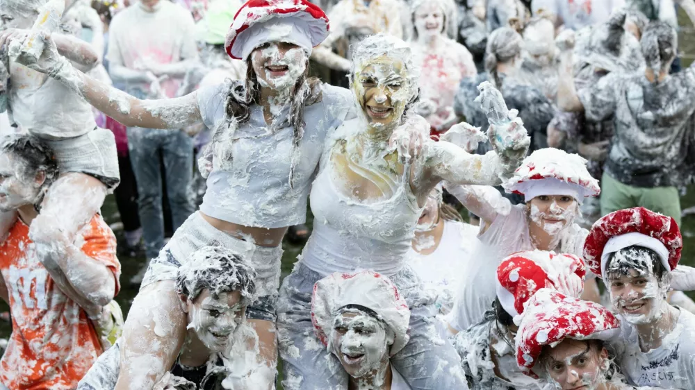 Students from St Andrews University are covered in foam as they leave after taking part in the traditional "Raisin Weekend" in the Lower College Lawn, at St Andrews in Scotland, Britain, October 21, 2024. REUTERS/Lesley Martin