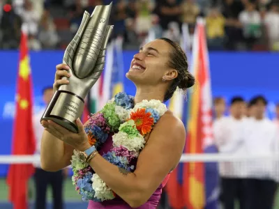 FILE PHOTO: Tennis - Wuhan Open - Optics Valley International Tennis Center, Wuhan, China - October 13, 2024 Belarus' Aryna Sabalenka celebrates with the trophy after winning her final match against China's Qinwen Zheng REUTERS/Florence Lo/File Photo