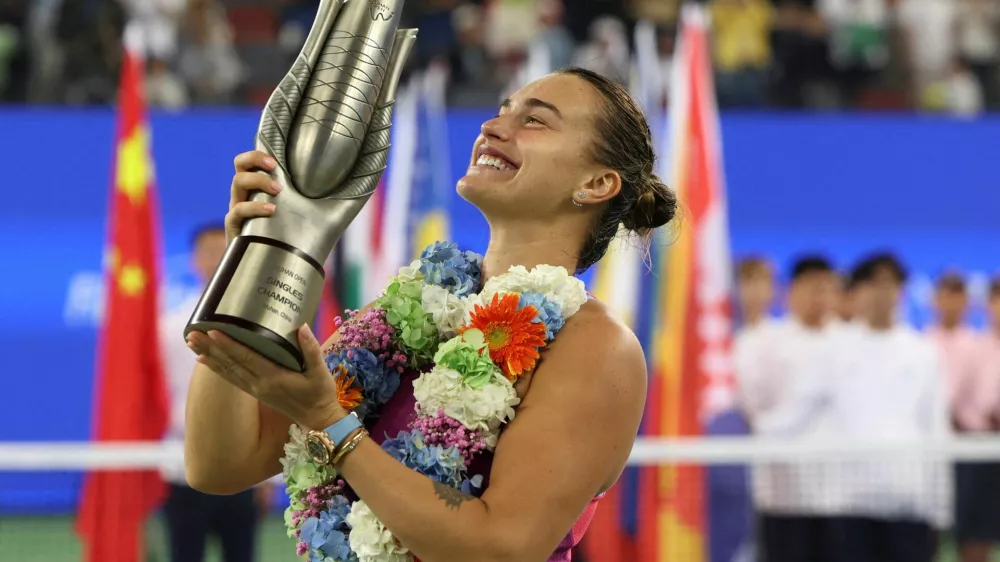 FILE PHOTO: Tennis - Wuhan Open - Optics Valley International Tennis Center, Wuhan, China - October 13, 2024 Belarus' Aryna Sabalenka celebrates with the trophy after winning her final match against China's Qinwen Zheng REUTERS/Florence Lo/File Photo