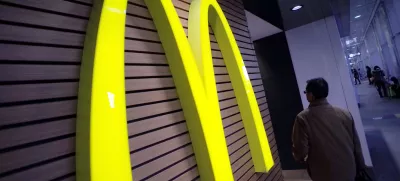 ﻿FILE - In this Dec. 17, 2014 file photo, a man walks by a McDonald's logo in front of its restaurant in Tokyo. McDonald's is set to unveil its latest plans to revive its sputtering business on Monday, May 4, 2015. (AP Photo/Eugene Hoshiko, File)