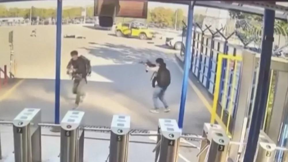 In this image take from security camera video shows two people with guns and backpacks during an attack on the premises of the Turkish state-run aerospace and defence company (TUSAS), on the outskirts of Ankara, Turkey, Wednesday Oct. 23, 2024. (Validated UGC via AP)