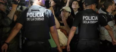 Police restrain fans gathering outside the hotel where former One Direction singer Liam Payne was found dead after he fell from a balcony in Buenos Aires, Argentina, Wednesday, Oct. 16, 2024. (AP Photo/Natacha Pisarenko)