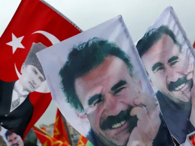 FILE PHOTO: Flags with a picture of the jailed Kurdish militant leader Abdullah Ocalan and of modern Turkey's founder Mustafa Kemal Ataturk (L) are pictured during a gathering of supporters of the Pro-Kurdish Peoples' Democratic Party (HDP) to celebrate the party's victory during the parliamentary election, in Istanbul, Turkey, June 8, 2015. REUTERS/Murad Sezer/File Photo