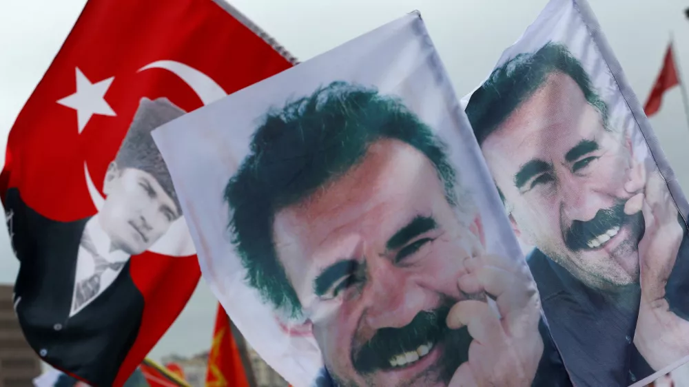 FILE PHOTO: Flags with a picture of the jailed Kurdish militant leader Abdullah Ocalan and of modern Turkey's founder Mustafa Kemal Ataturk (L) are pictured during a gathering of supporters of the Pro-Kurdish Peoples' Democratic Party (HDP) to celebrate the party's victory during the parliamentary election, in Istanbul, Turkey, June 8, 2015. REUTERS/Murad Sezer/File Photo