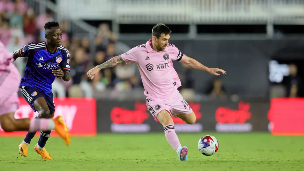 Oct 7, 2023; Fort Lauderdale, Florida, USA; Inter Miami CF forward Lionel Messi (10) dribbles the ball against FC Cincinnati midfielder Obinna Nwobodo (5) during the second half at DRV PNK Stadium. Mandatory Credit: Sam Navarro-USA TODAY Sports