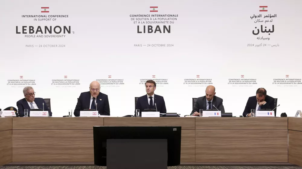 France's President Emmanuel Macron, center, Lebanon's Prime Minister caretaker Prime Minister Najib Mikati, second left, Lebanon's Foreign Affairs Minister Abdallah Bou Habib, left, France's Foreign Affairs Minister Jean-Noel Barrot, second right, and France's Defense Minister Sebastien Lecornu, right, attend an international conference for Lebanon in Paris, Thursday, Oct.24, 2024. (Alain Jocard, Pool via AP)