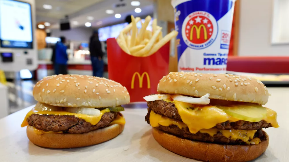 FILE- In this March 6, 2018, file photo, a McDonald's Quarter Pounder, left, and Double Quarter Pound burger is shown in Atlanta. (AP Photo/Mike Stewart, File)