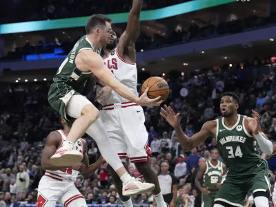 Oct 25, 2024; Milwaukee, Wisconsin, USA; Milwaukee Bucks guard Pat Connaughton (24) drives to the basket against Chicago Bulls forward Patrick Williams (44) in the second half at Fiserv Forum. Mandatory Credit: Michael McLoone-Imagn Images