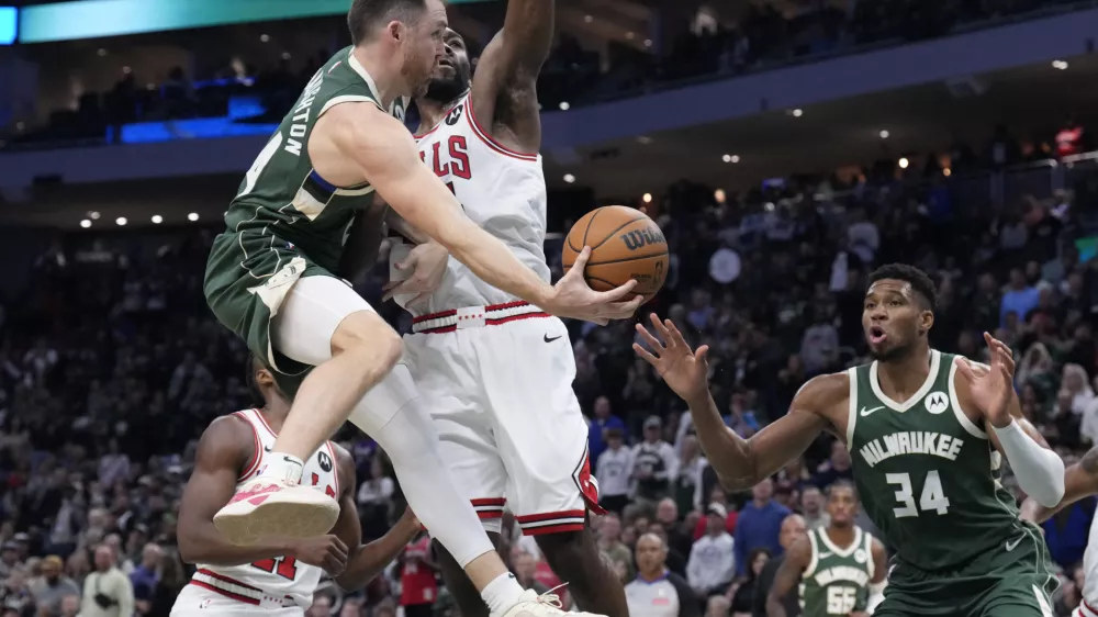 Oct 25, 2024; Milwaukee, Wisconsin, USA; Milwaukee Bucks guard Pat Connaughton (24) drives to the basket against Chicago Bulls forward Patrick Williams (44) in the second half at Fiserv Forum. Mandatory Credit: Michael McLoone-Imagn Images