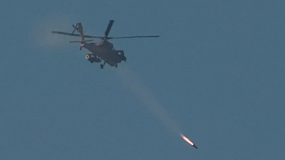 An Israeli Apache attack helicopter fires a missile towards southern Lebanon, amid ongoing hostilities between Hezbollah and Israel, as seen from near Ein Ya'akov, northern Israel, October 26, 2024. REUTERS/Gonzalo Fuentes