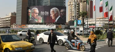 Iranians walk next to an anti-U.S. and Israeli billboard with pictures of Iranian President Masoud Pezeshkian and Iranian Armed Forces Chief of Staff, Major General Mohammad Bagheri and U.S. President Joe Biden and Israel's Prime Minister Benjamin Netanyahu, on a street in Tehran, Iran, October 27, 2024. Majid Asgaripour/WANA (West Asia News Agency) via REUTERS ATTENTION EDITORS - THIS IMAGE HAS BEEN SUPPLIED BY A THIRD PARTY  ATTENTION EDITORS - THIS PICTURE WAS PROVIDED BY A THIRD PARTY