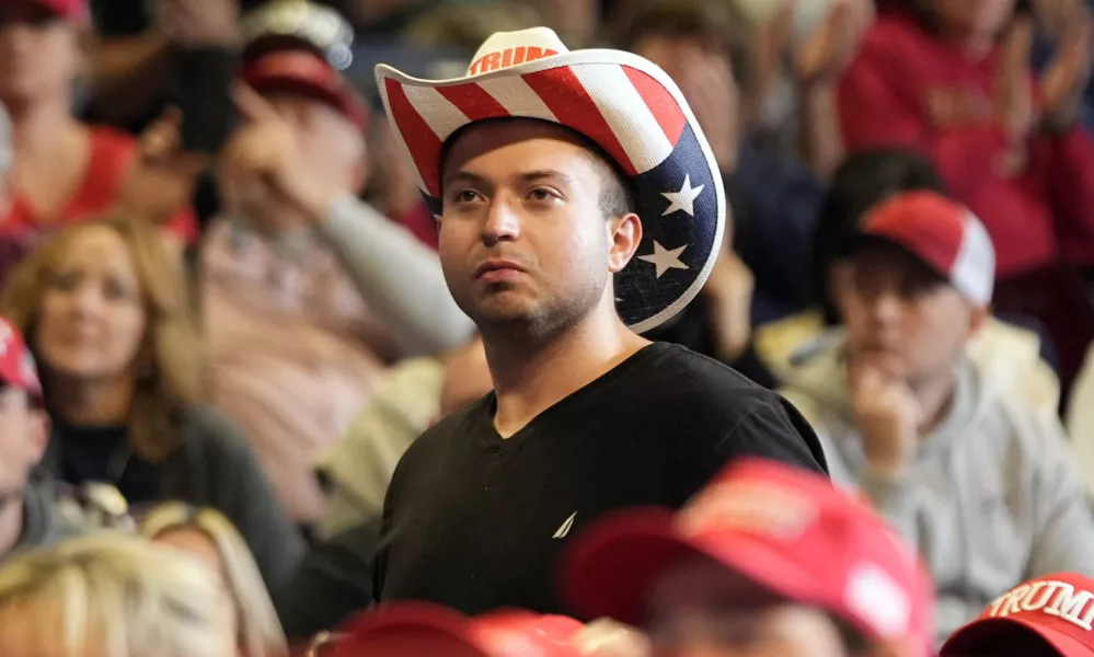 A supporter listens as Republican presidential nominee former President Donald Trump speaks at a campaign rally at the Bryce Jordan Center, Saturday, Oct. 26, 2024, in State College, Pa. (AP Photo/Alex Brandon)