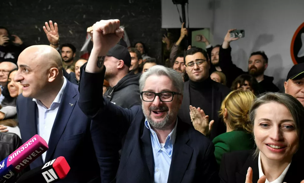 Nika Melia and Nika Gvaramia, leaders of the Coalition for Change, and Nana Malashkhia, who leads the coalition's parliament list, react after the announcement of exit poll results in parliamentary elections, in Tbilisi, Georgia October 26, 2024. REUTERS/Zurab Javakhadze