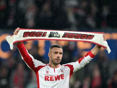 10 October 2024, North Rhine-Westphalia, Cologne: German footballer Lukas Podolski celebrates with the fans during the Lukas Podolski's farewell match. Photo: Federico Gambarini/dpa