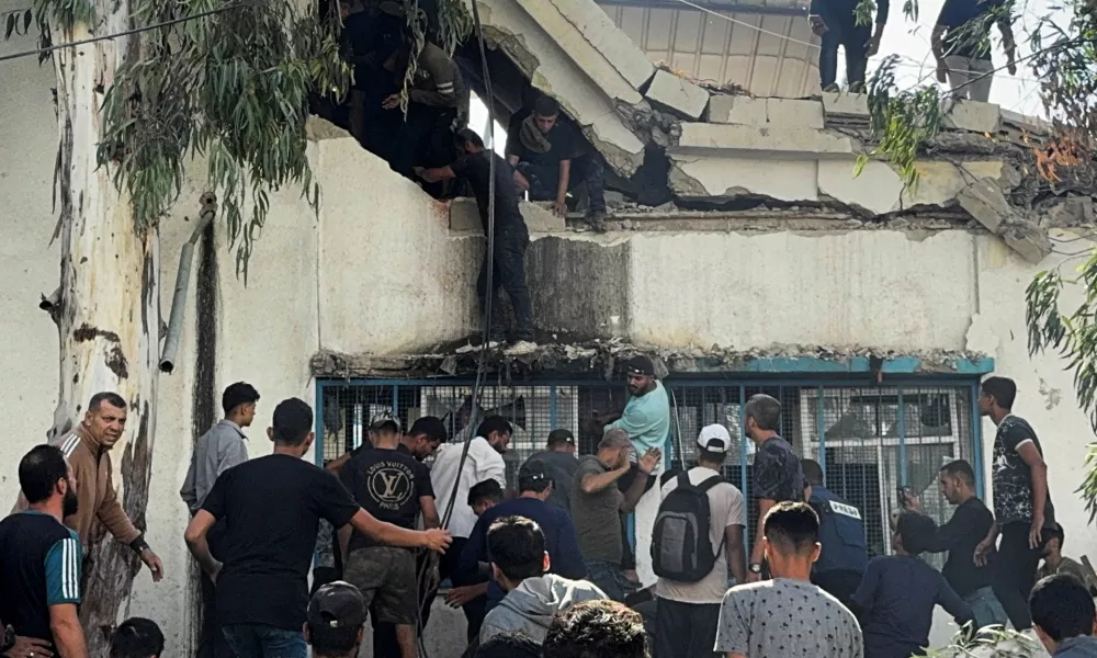 Palestinians inspect the site of an Israeli strike on a school sheltering displaced people, amid the ongoing Israel-Hamas conflict, in Gaza City, October 27, 2024. REUTERS/Ayman Al Hassi