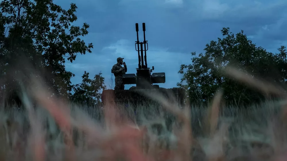 FILE PHOTO: A Ukrainian serviceman from an anti-drone mobile air defence unit smokes near a ZU-23-2 anti aircraft cannon as he waits for Russian kamikaze drones, amid Russia's attack on Ukraine, in Kherson region, Ukraine June 11, 2024. REUTERS/Ivan Antypenko/File Photo