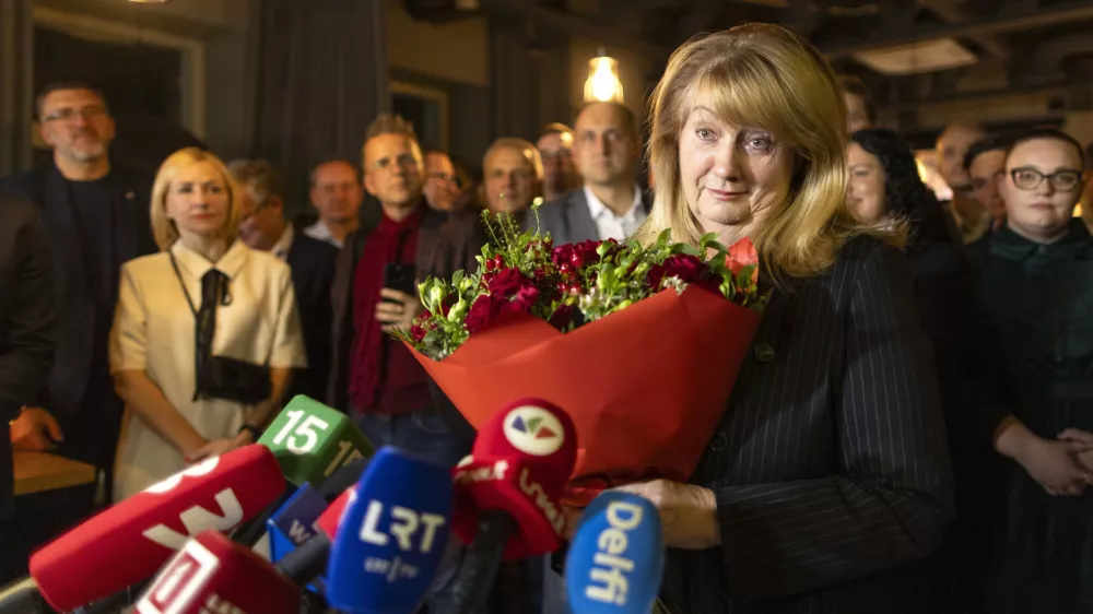 Leader of the Social Democratic Party Vilija Blinkeviciute speaks to the media while waiting for the results of the second round of Lithuania's parliamentary election, in an office in Vilnius, Lithuania, Sunday, Oct. 27, 2024. (AP Photo/Mindaugas Kulbis)