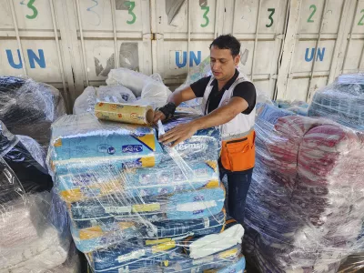 FILE - United Nations and Red Crescent workers prepare the aid for distribution to Palestinians at UNRWA warehouse in Deir Al-Balah, Gaza Strip, on Monday, Oct. 23, 2023. (AP Photo/Hassan Eslaiah, File)